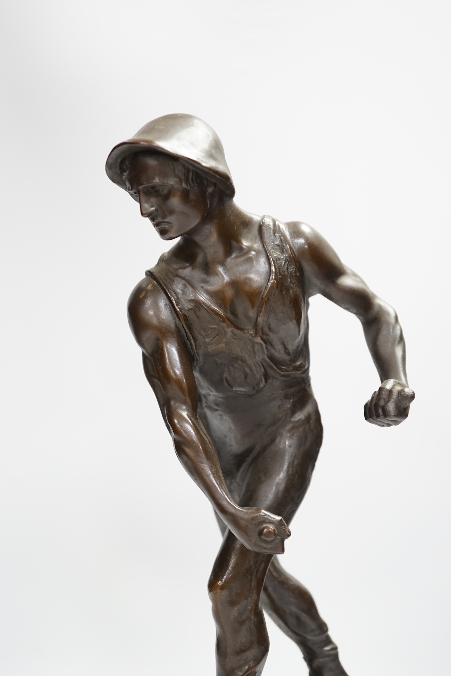 German School, an early 20th century bronze of a farmer. Condition - implement missing, overall fair